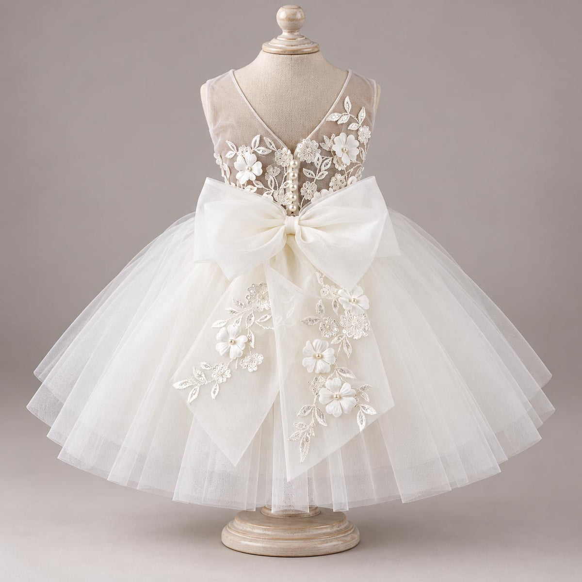 MOON FLOWER ivory dog wedding dress with floral embroidery and oversized bow on a mannequin